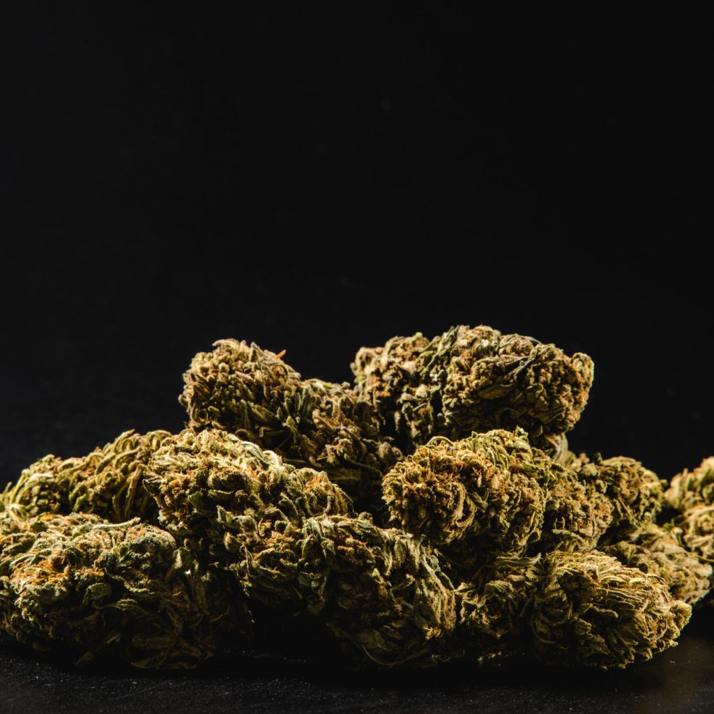 Pile of marijuana buds on a black background. Cannabis concept.